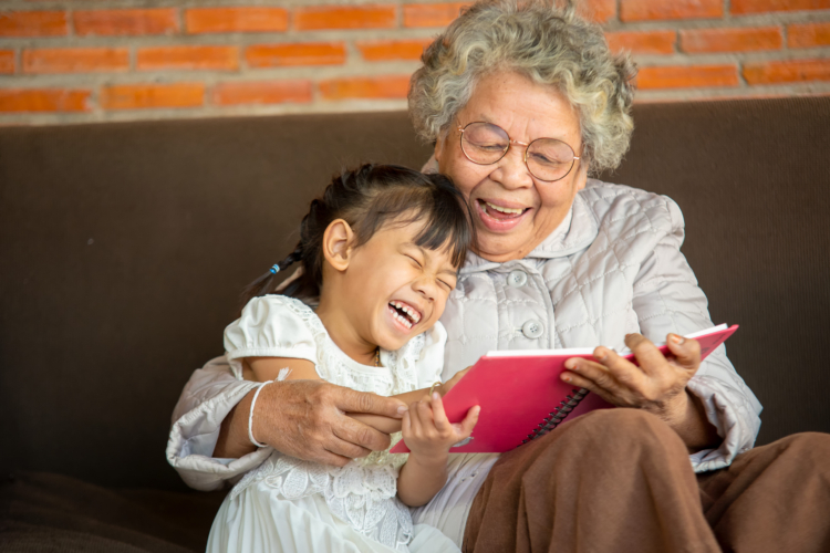 Child and older woman reading together